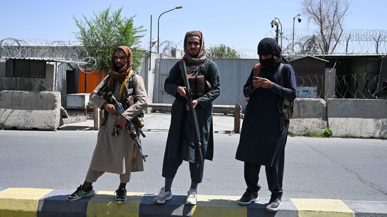 Taliban fighters stand guard along a street in Kabul on August 16, 2021.