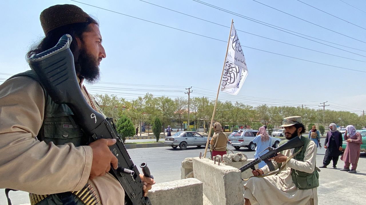 Taliban fighters stand guard at an entrance gate outside the Interior Ministry in Kabul on August 17, 2021. 