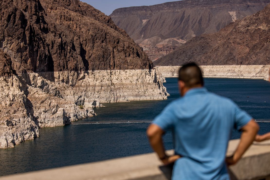 A visitor at the Hoover Dam Lookout observation deck above the Colorado River during low water levels in Arizona, Nevada, U.S., on Thursday, Aug. 19, 2021. 