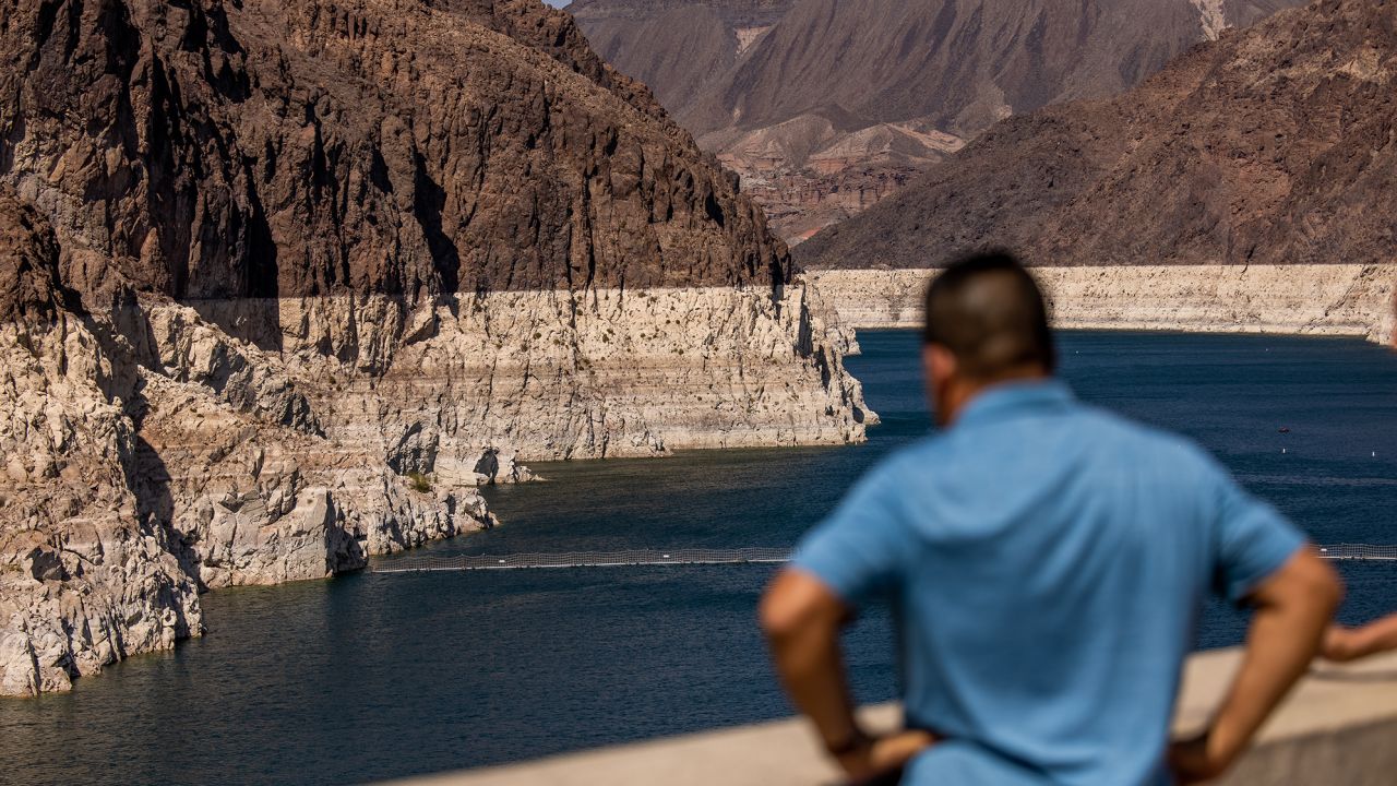 A visitor at the Hoover Dam Lookout observation deck above the Colorado River during low water levels in Arizona, Nevada, U.S., on Thursday, Aug. 19, 2021. 