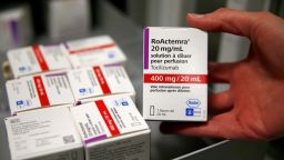 FILE PHOTO: A pharmacist displays a box of tocilizumab, which is used in the treatment of rheumatoid arthritis, at the pharmacy of Cambrai hospital, France, April 28, 2020. REUTERS/Pascal Rossignol/File Photo