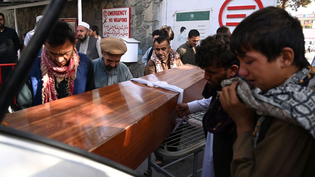 Relatives load the coffin of a victim of the August 26 suicide bombs into a car in Kabul on August 27, 2021.