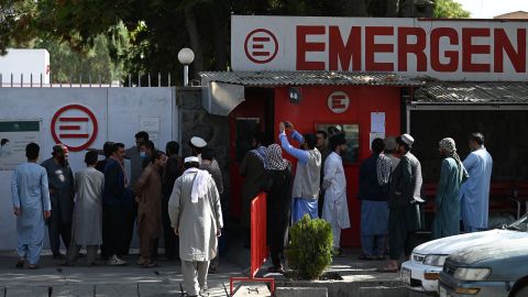 People gather to check on missing relatives on Friday.