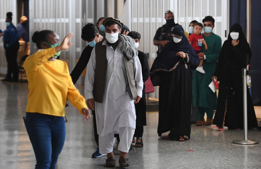 Afghan refugees arrive at Dulles International Airport on Friday in Dulles, Virginia, after being evacuated from Kabul following the Taliban takeover of Afghanistan.