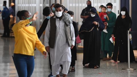 Afghan refugees arrive at Dulles International Airport on Friday in Dulles, Virginia, after being evacuated from Kabul following the Taliban takeover of Afghanistan.