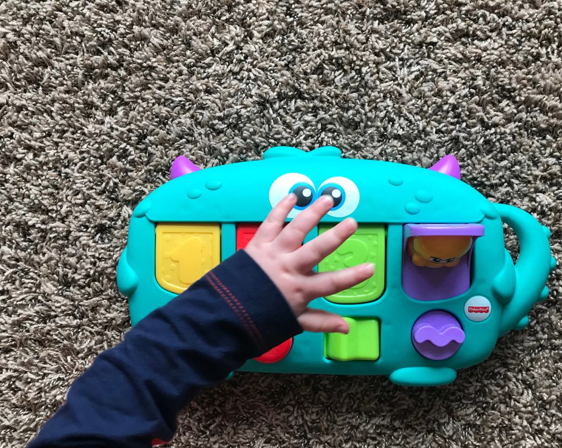 A child playing with Fisher-Price Monster Pop-Up Surprise in Tiffin, Iowa in 2019.