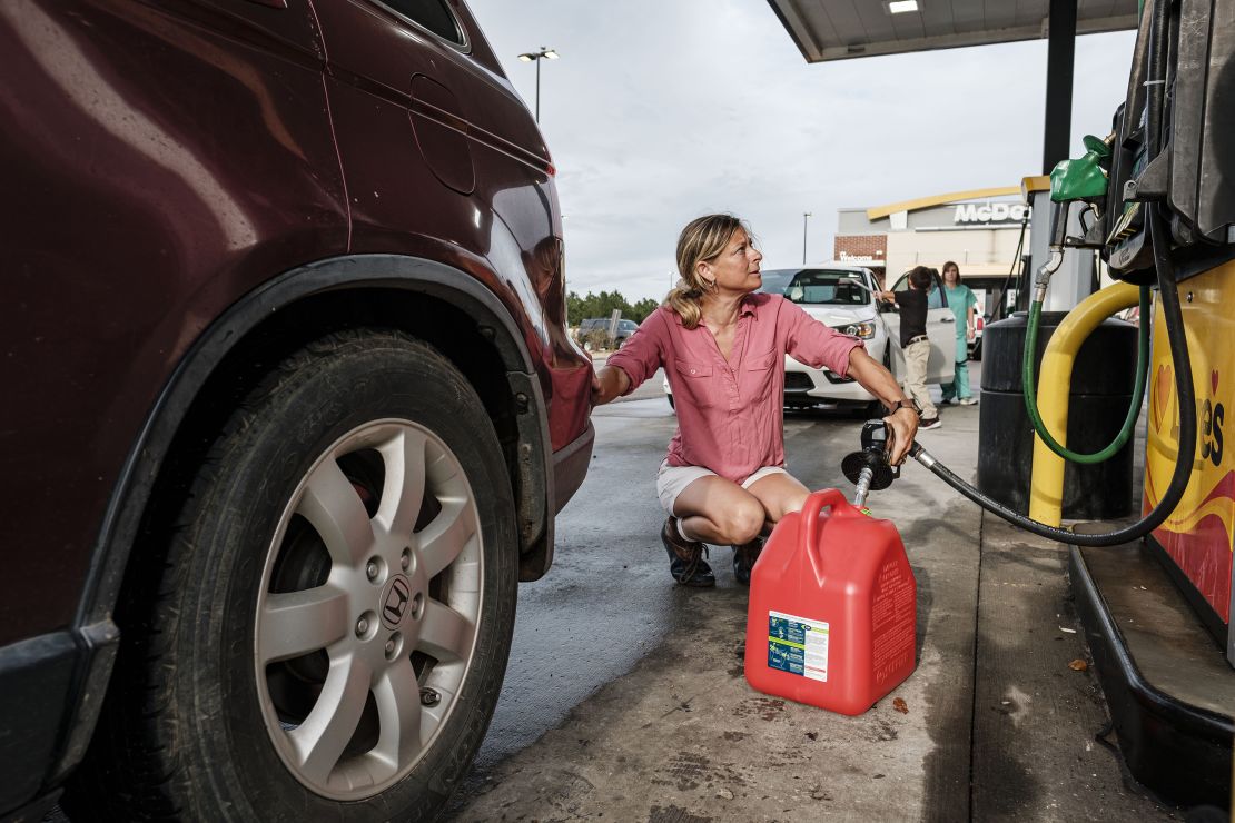 Jennifer Tate fueled up a gas can in advance of the arrival of Hurricane Ida in Pass Christian, Mississippi, on August 27, 2021. 