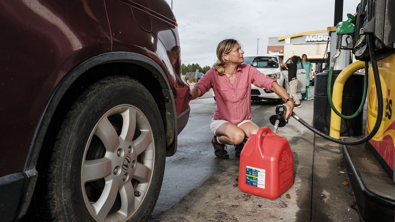Jennifer Tate fueled up a gas can in advance of the arrival of Hurricane Ida in Pass Christian, Mississippi, on August 27, 2021. 