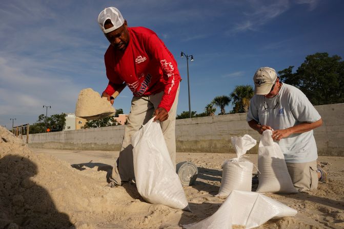 Gregory Moore, left, helps fill sand bags as residents in Gulfport, Mississippi, prepared for the storm on August 28.