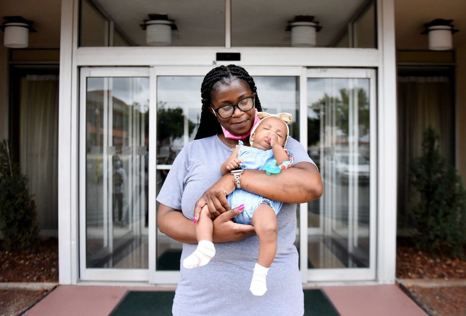 Nikeia Washington holds her granddaughter, Halia Zenon, at a hotel in downtown Shreveport, Louisiana, where they evacuated ahead of the storm.