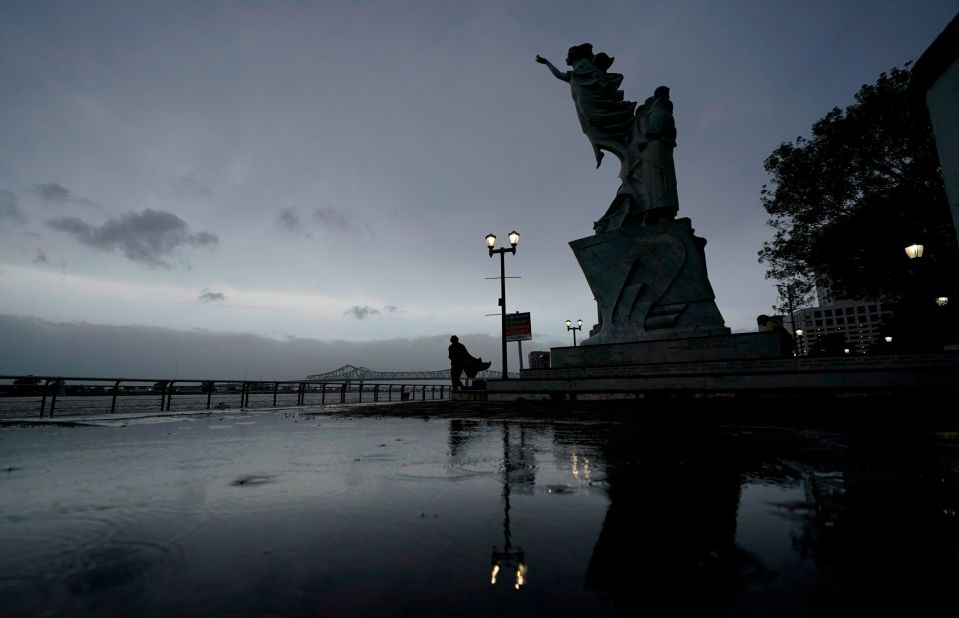 A man walks along the Mississippi River near the French Quarter in New Orleans early on August 29.