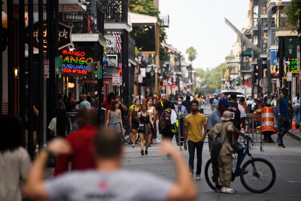 People walk down Bourbon Street in New Orleans on August 28. <a href="https://www.cnn.com/2021/08/27/us/new-orleans-hurricane-ida-preparations/index.html" target="_blank">Evacuation was voluntary</a> for parts of the city inside its flood protection system. Other areas were under a mandatory evacuation order.