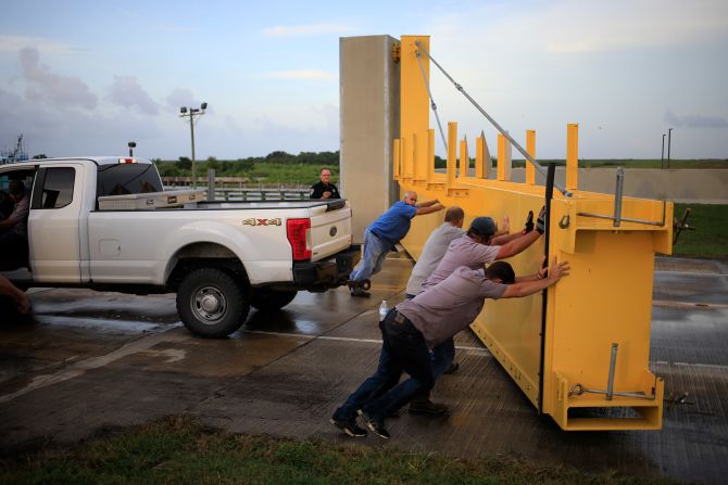 Crews reopen a flood gate to help trapped motorists who missed a closure deadline on August 28.