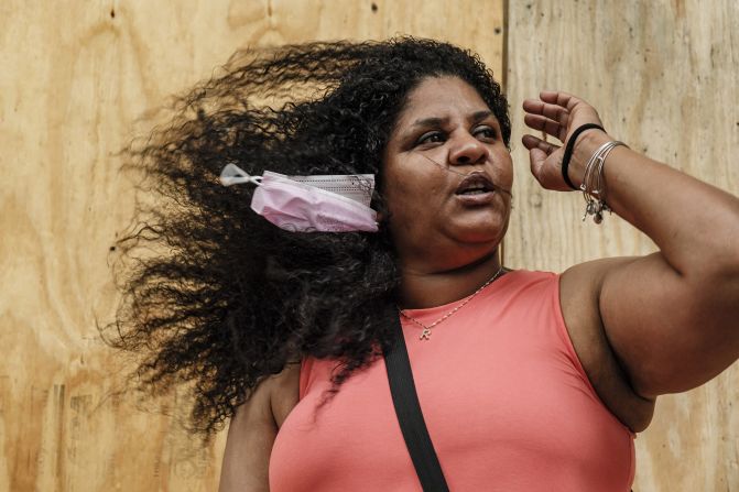 Wind blows Monroe Best's hair and face mask in New Orleans.