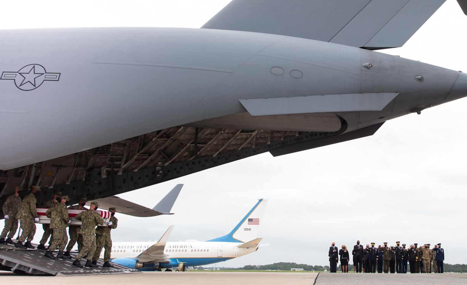 Biden and other officials watch as flag-draped cases carrying the remains of American service members killed in Afghanistan <a href="index.php?page=&url=https%3A%2F%2Fwww.cnn.com%2F2021%2F08%2F29%2Fpolitics%2Fbiden-dover-afghanistan-service-members-killed%2Findex.html" target="_blank">return to the United States</a> in August 2021.