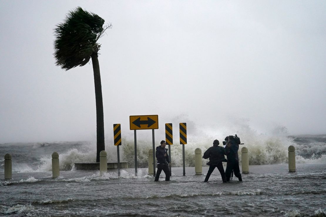 A news crew reports on the edge of Lake Pontchartrain ahead of approaching Hurricane Ida in New Orleans, Sunday, August 29, 2021. 