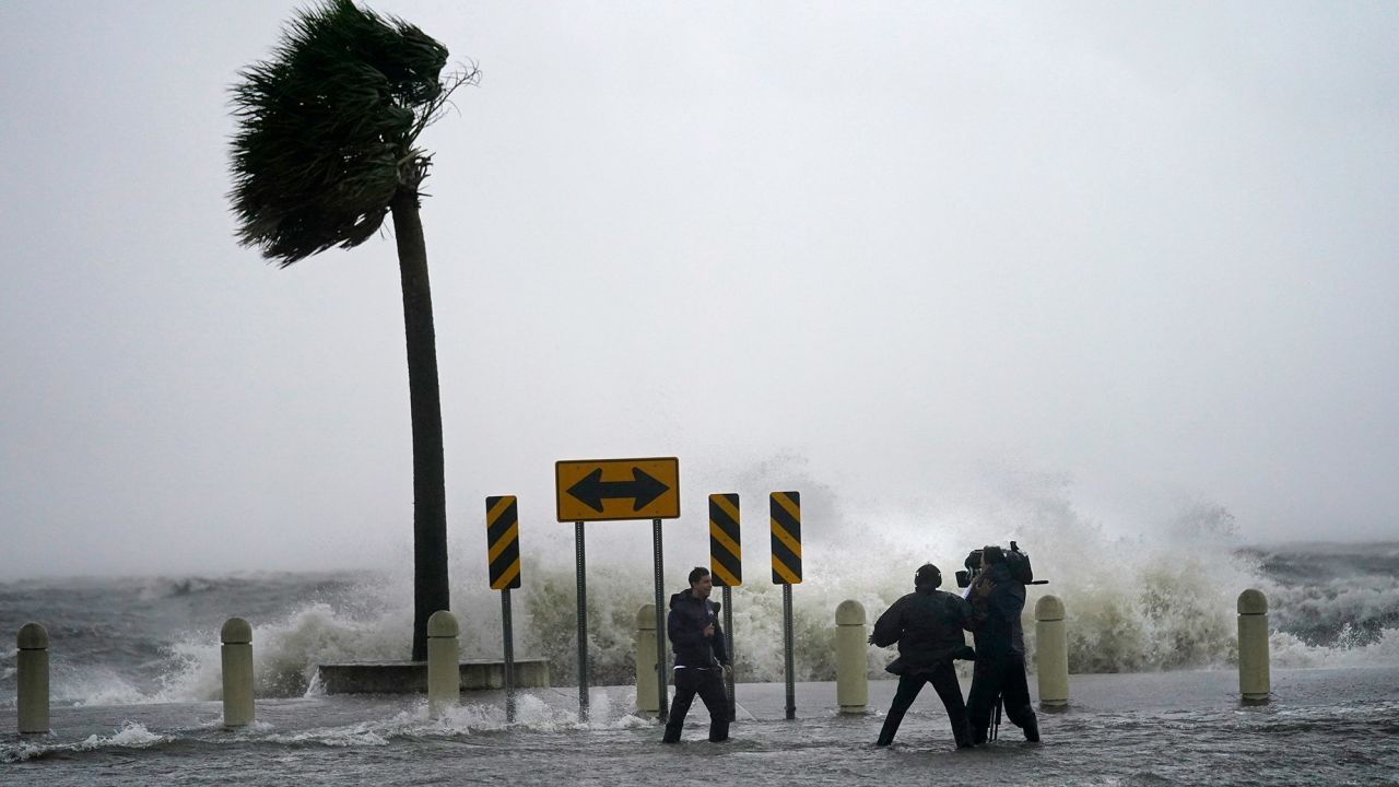 A news crew reports on the edge of Lake Pontchartrain ahead of approaching Hurricane Ida in New Orleans, Sunday, August 29, 2021.