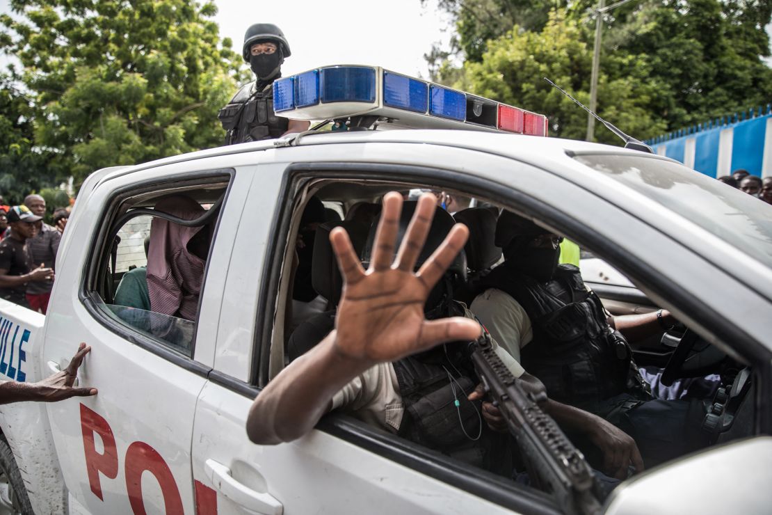 Haitian police transport two alleged suspects to a Port-au-Prince police station on July 8. 

