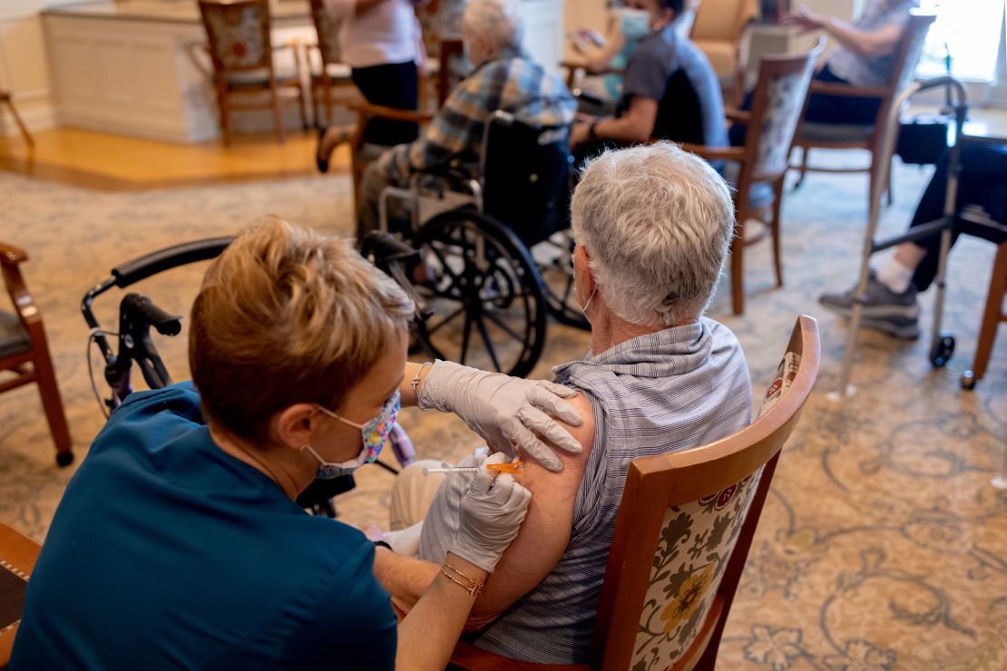 A healthcare worker administers a third dose of the Pfizer-BioNTech Covid-19 vaccine at a senior living facility in Worcester, Pennsylvania.