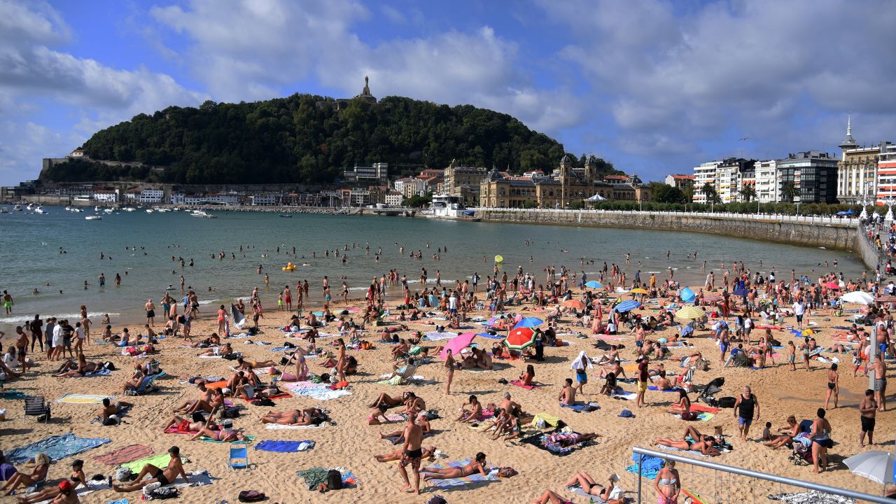 People are seen at the Beach of the Concha in San Sebastian Guipuzkoa, Spain, on Tuesday.