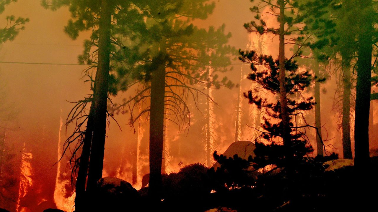 The Caldor Fire burns on both sides of the US-50 11 miles from the Meyers neighborhood in South Lake Tahoe.