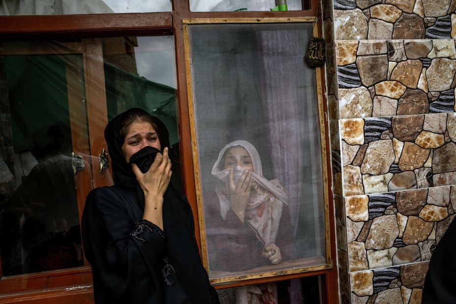 Samia Ahmadi, right, whose father and fiancé were both dead following the US drone strike, mourns her loved ones on August 30.