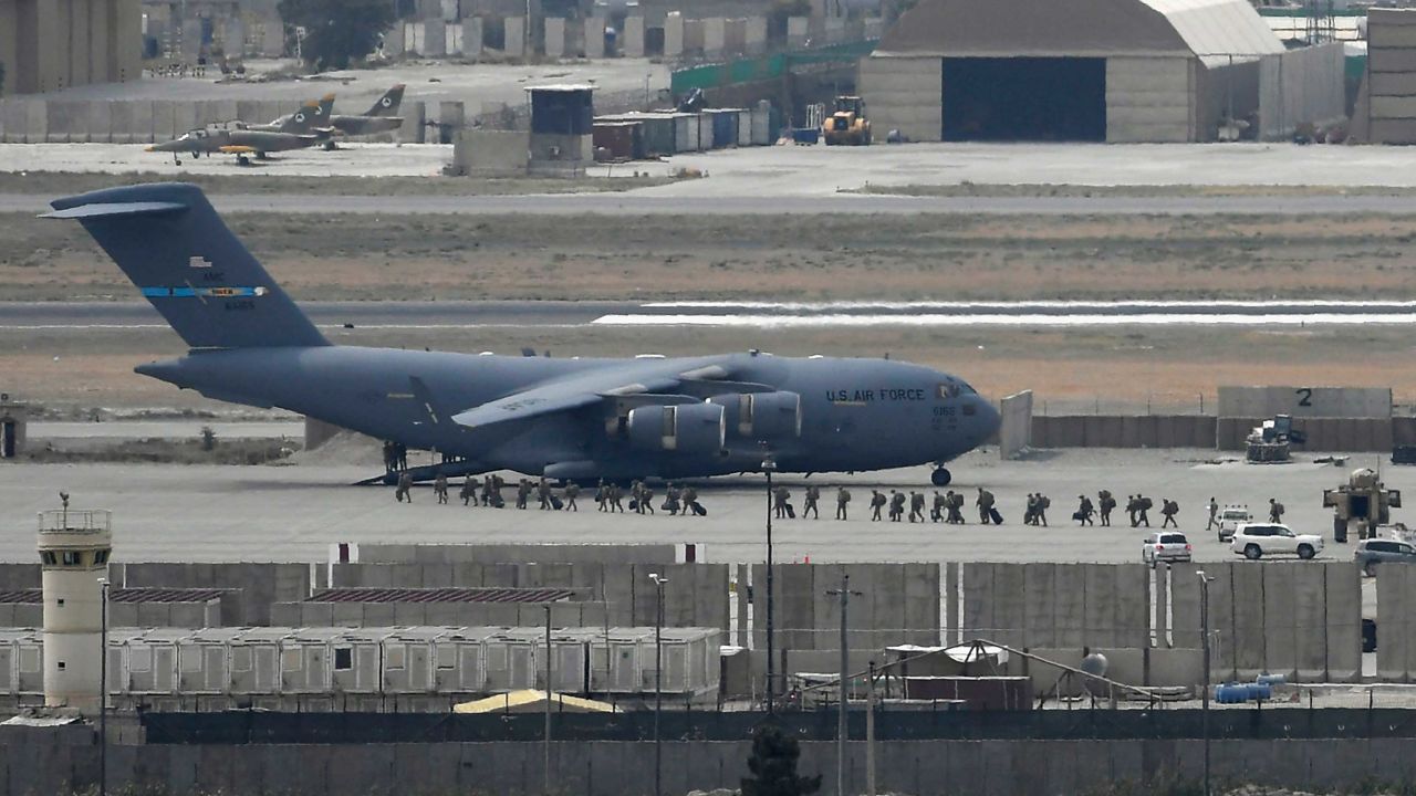 US soldiers board an US Air Force aircraft at the airport in Kabul on August 30, 2021.  