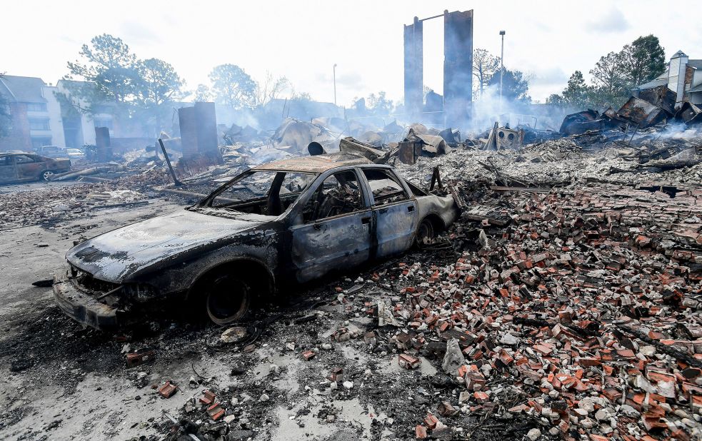 A destroyed car is seen after an apartment building burned overnight in Kenner, Louisiana.