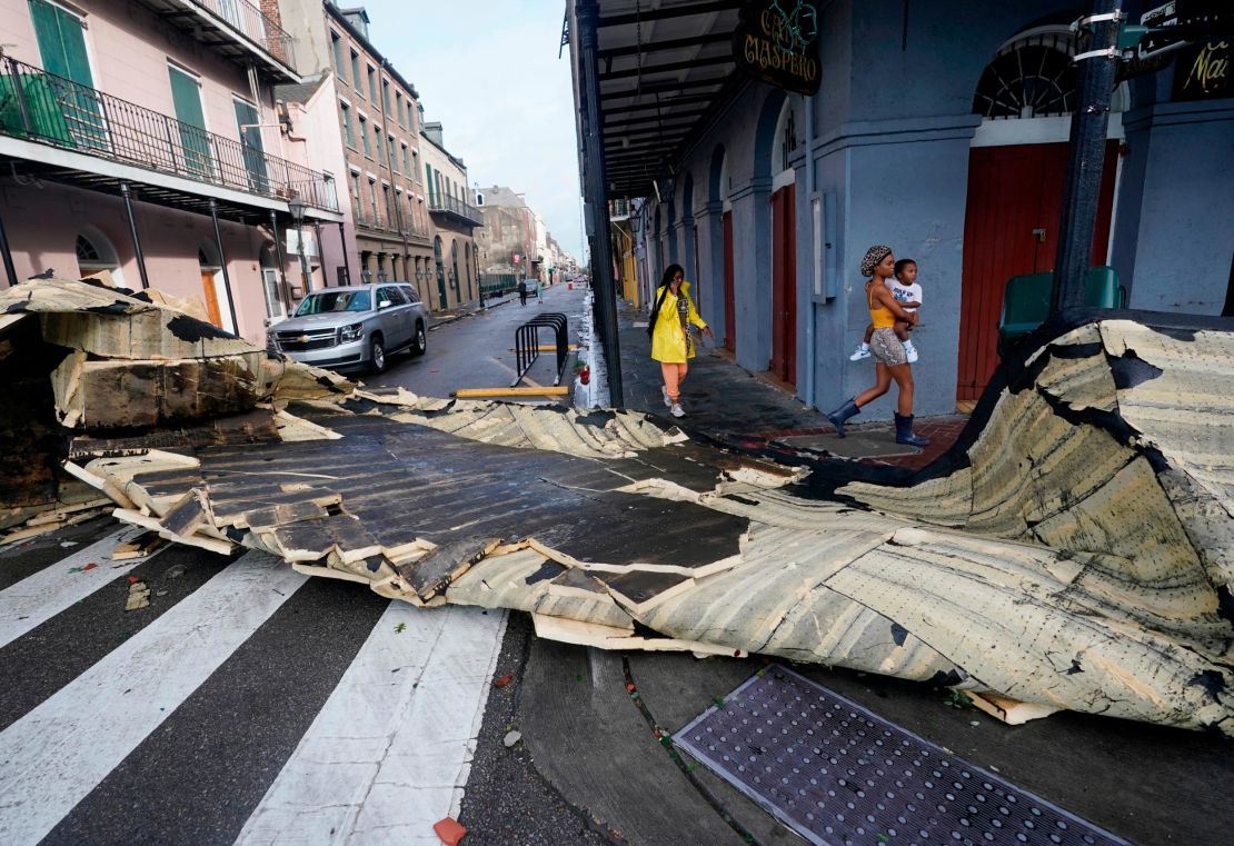 A section of roof blocks an intersection in the French Quarter of New Orleans.