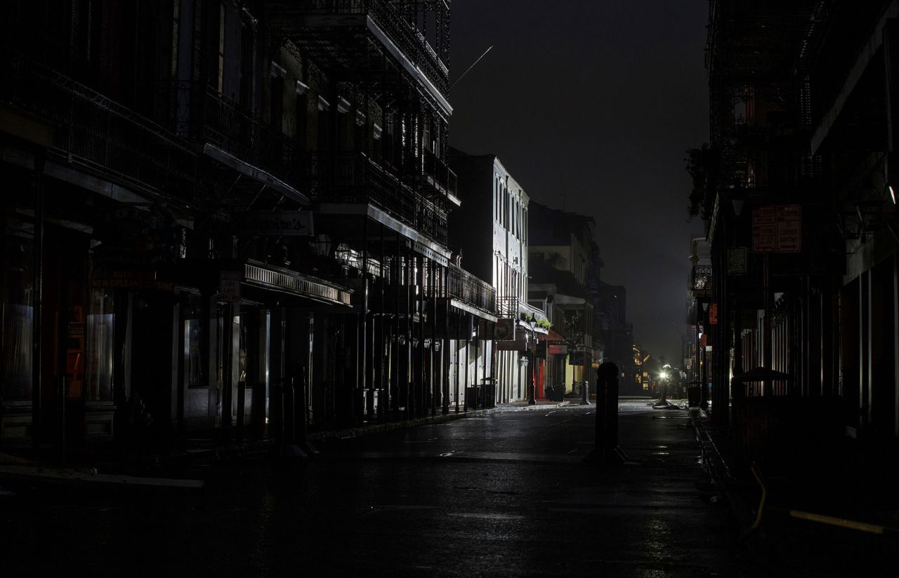 Lights from a TV broadcast illuminate an otherwise dark Bourbon Street in New Orleans on August 30.