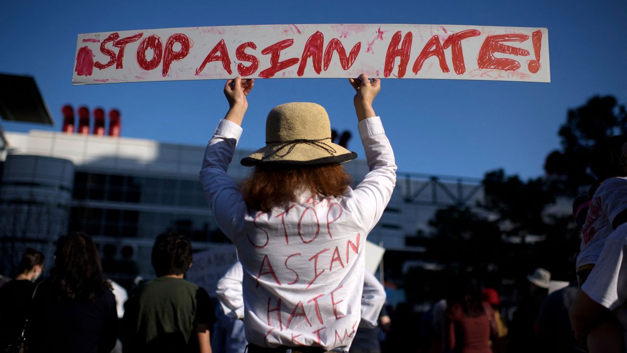 A woman holds up a sign during a Stop Asian Hate rally at Discovery Green in downtown Houston earlier this year.