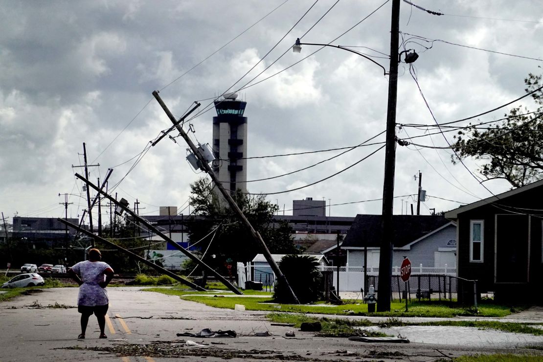 A woman looks over damage to a neighborhood in Kenner, Louisiana, on Monday.