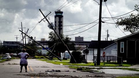 A woman looks over damage to a neighborhood in Kenner, Louisiana, on Monday. 