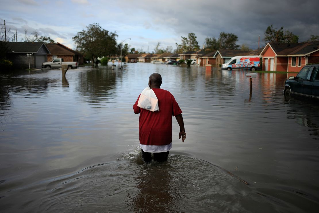 A resident walks through floodwater left behind by Hurricane Ida in LaPlace, Louisiana, on August 30, 2021. 