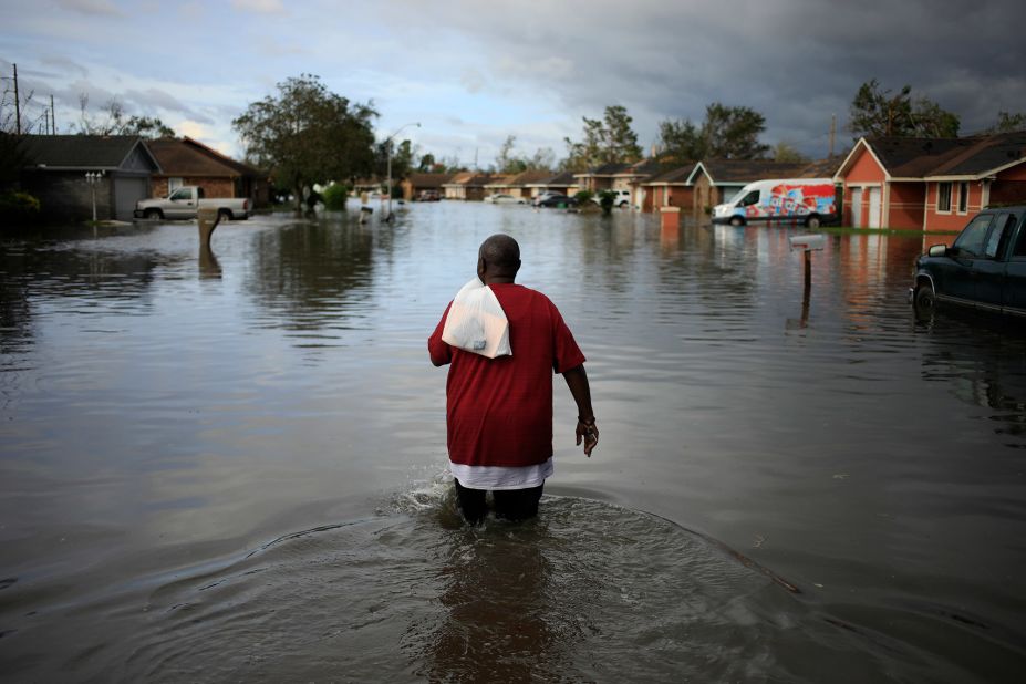 A resident walks through floodwaters in LaPlace on August 30.