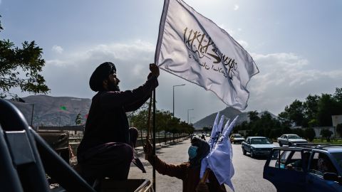 A boy selling Taliban flags in Kabul. Most of the country does not remember the previous era of Taliban rule, which ended in 2001.