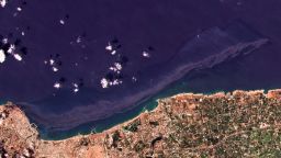 In this satellite photo from Planet Labs Inc., an oil spill is seen stretching off the coast near Baniyas, Syria, Tuesday, Aug. 24, 2021. The massive oil spill caused by leakage from a power plant inside the Baniyas Thermal Station, one of Syria's oil refineries is spreading along the coast of the Mediterranean country, Syria's state news agency said and satellite photos showed Wednesday. (Planet Labs Inc. via AP)