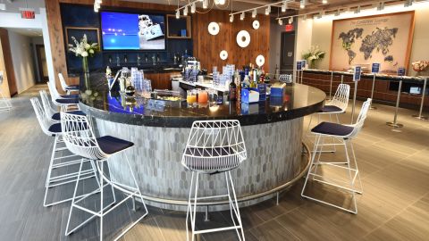 Grab a drink from the bar at the Amex Centurion Suite at the US Open.