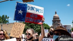 Protesters hold up signs as they march down Congress Ave at a protest outside the Texas state capitol on May 29, 2021 in Austin, Texas. Thousands of protesters came out in response to a new bill outlawing abortions after a fetal heartbeat is detected signed on Wednesday by Texas Governor Greg Abbot. 