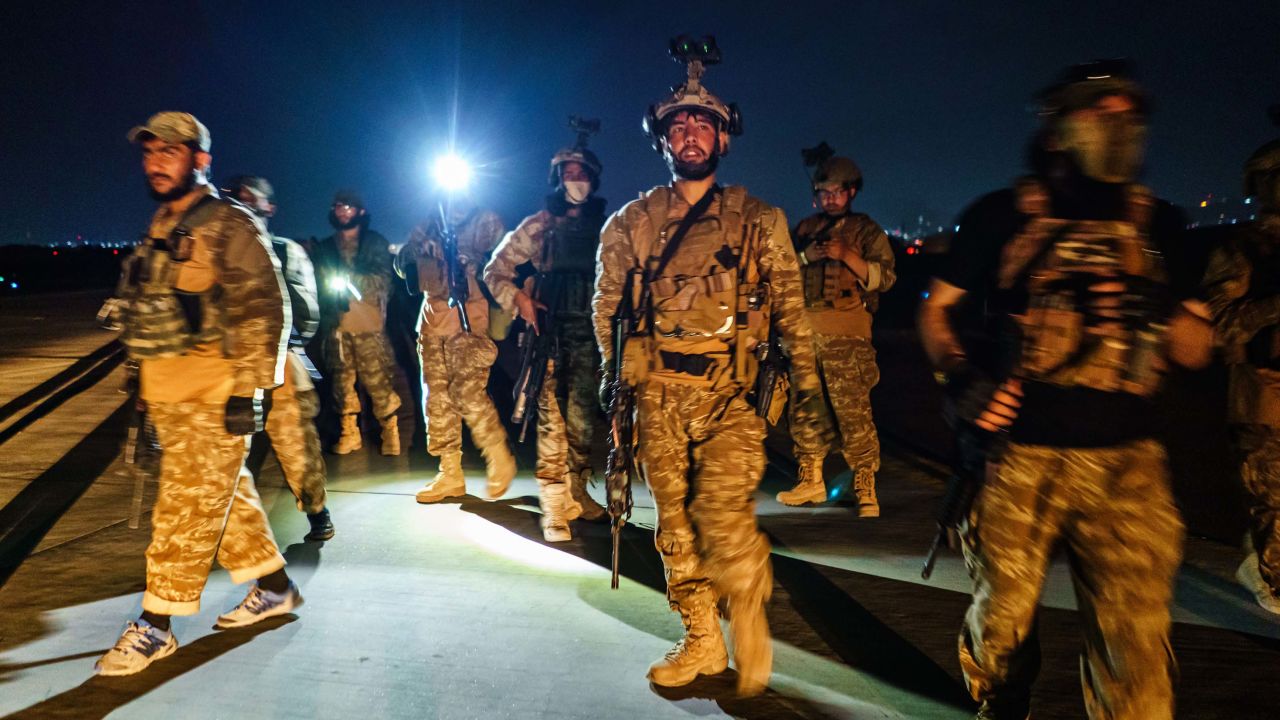 Taliban fighters wielding American supplied weapons secure Kabul airport early Tuesday.  