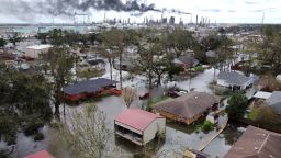 Homes near Norco, La., are surrounded by floodwater as chemical refineries continue to flare the day after Hurricane Ida hit southern Louisiana, Monday, Aug. 30, 2021. (Chris Granger/The Times-Picayune/The New Orleans Advocate via AP)