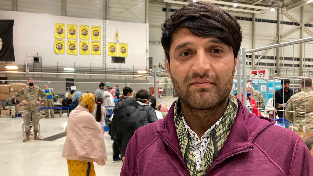 Asadullah Sadiqi, 25, waits to board a flight from Ramstein Air Base for Virginia to join his family.
