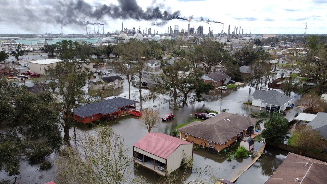 Homes near Norco, Louisiana, are surrounded by floodwater as chemical refineries continue to flare the day after Hurricane Ida hit southern Louisiana on August 30, 2021. 