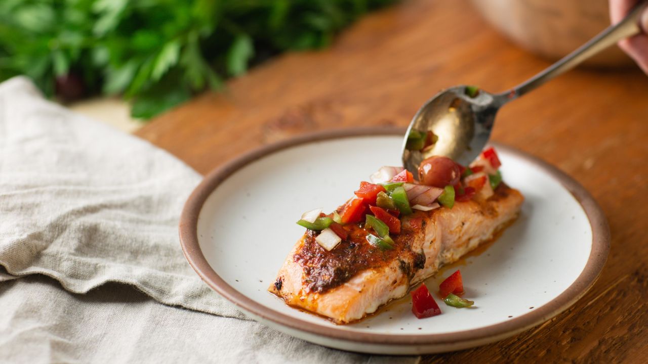 Carefully spoon the marinade over the salmon.