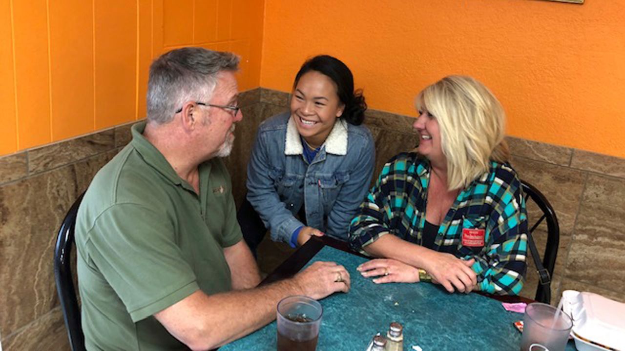 Shepherd is pictured with her adopted parents, Rob and Shelly, in 2018.
