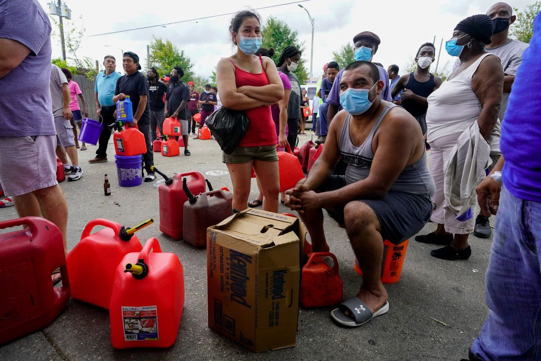 In the aftermath of Hurricane Ida, people wait in line for gas Tuesday in New Orleans.