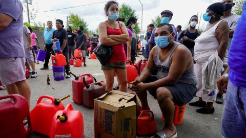 In the aftermath of Hurricane Ida, people wait in line for gas Tuesday in New Orleans.