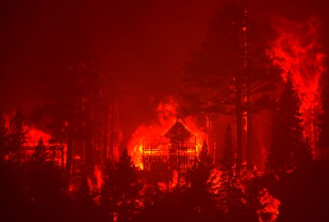 The Caldor Fire burns homes along a ridge near South Lake Tahoe on August 30. 