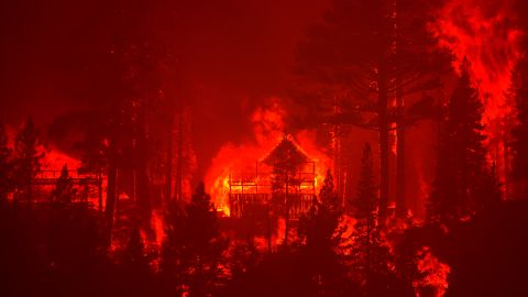 The Caldor Fire burns homes along a ridge near South Lake Tahoe, California, on August 30, 2021.