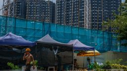 Construction workers near the Emerald Bay residential project developed by China Evergrande in the Tuen Mun district of the New Territories in Hong Kong, China, on July 23, 2021. 